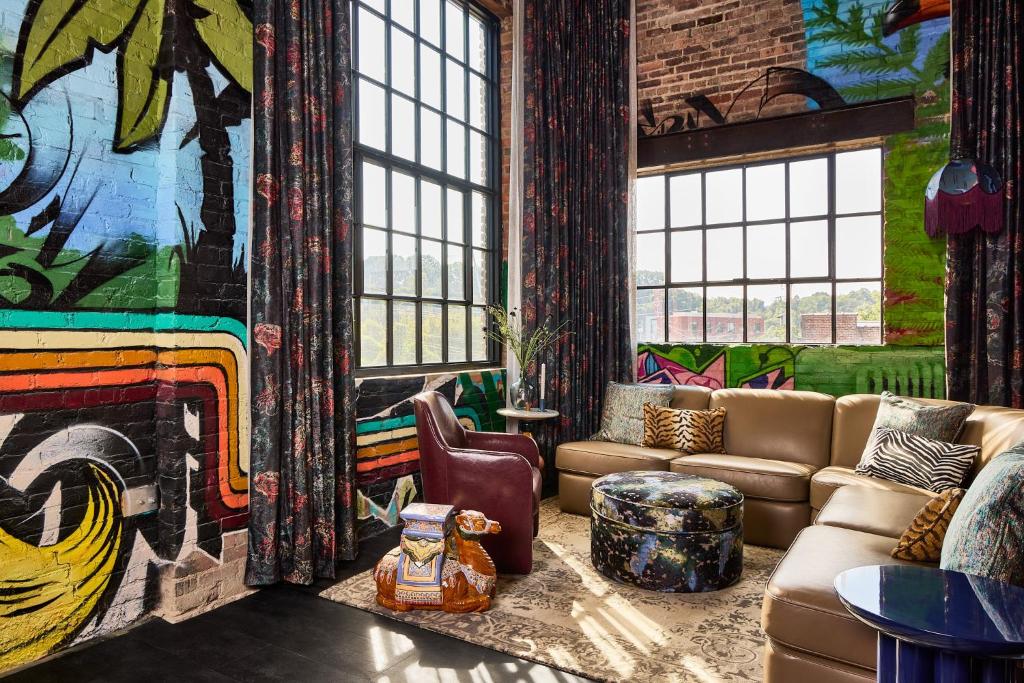 a living room with a couch and a wall of windows at The Radical in Asheville