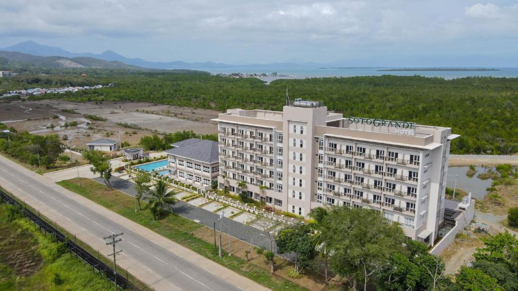 an aerial view of a hotel building with a road at Sotogrande Hotel Palawan in Puerto Princesa City
