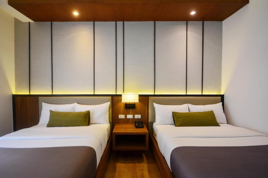 Postel nebo postele na pokoji v ubytování Sotogrande Hotel Palawan
