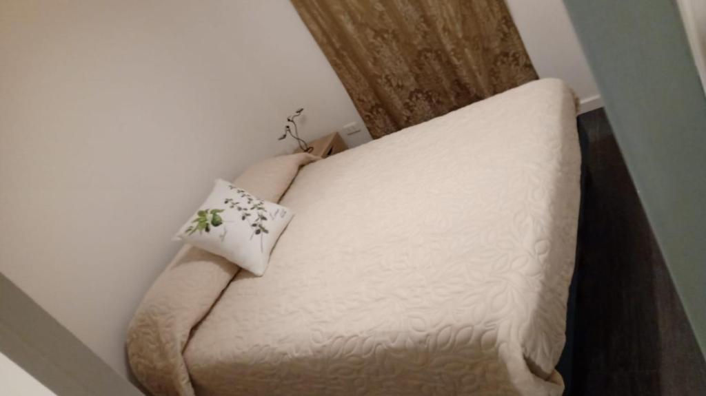 a white couch sitting in a corner of a room at Casa Paso Jama in San Pedro de Atacama