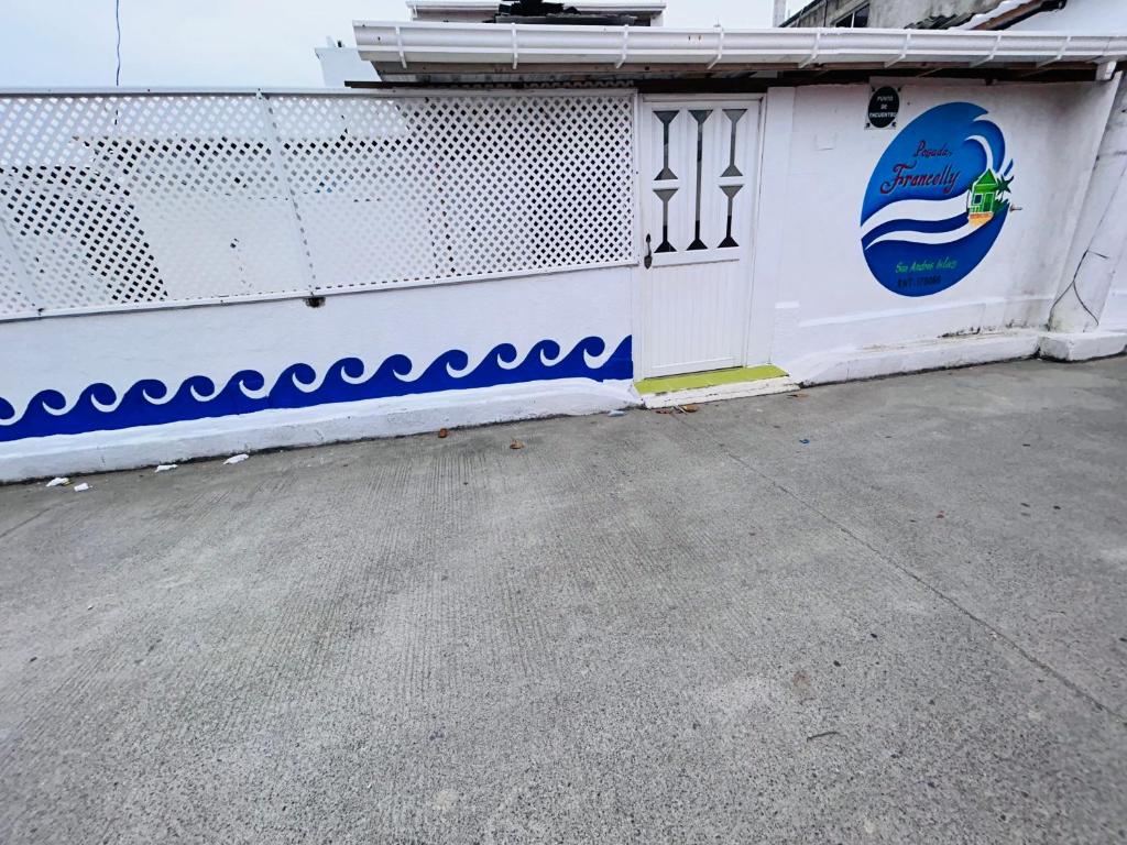 a white fence with blue and white paint on it at Posada Francelly in San Andrés