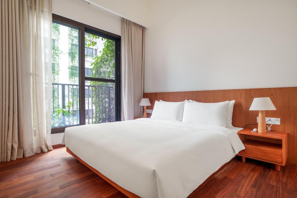 Postel nebo postele na pokoji v ubytování Wutong Hotel Apartment Bao'an Center