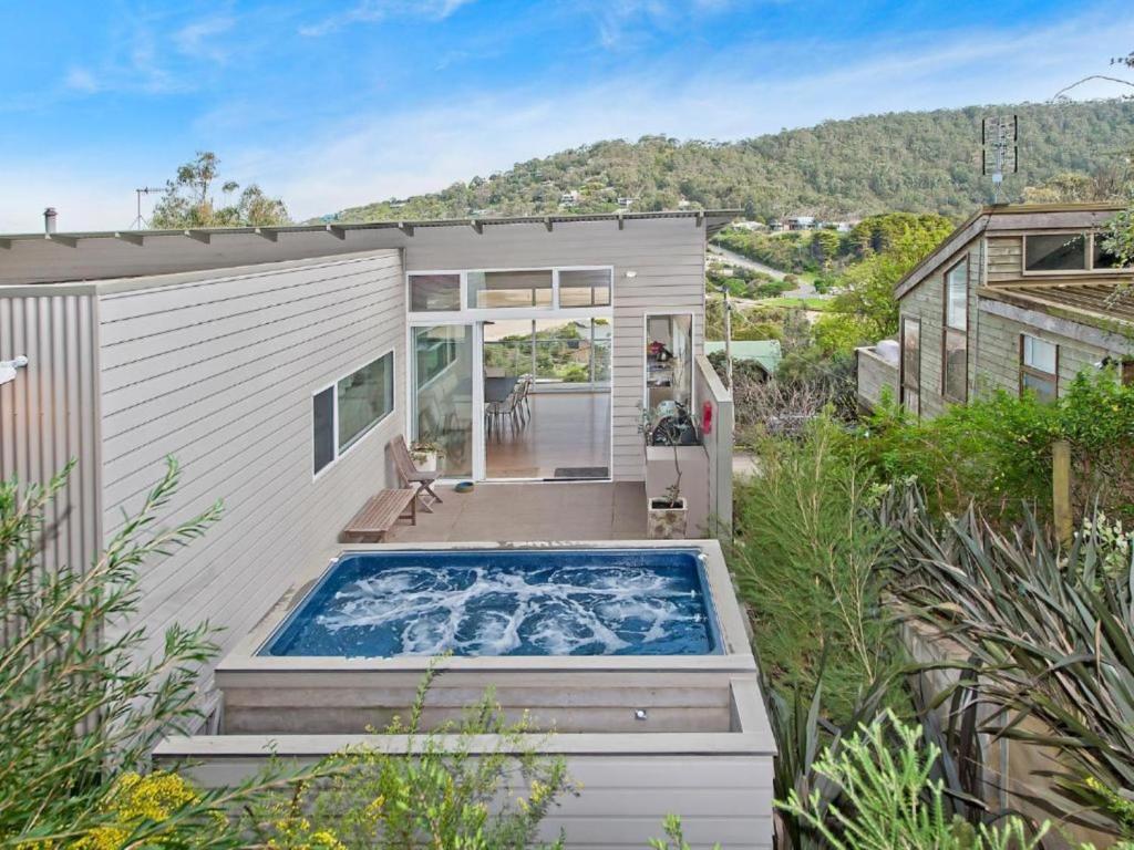 an exterior view of a tiny house with a swimming pool at Drift - Luxury, location and ocean views in Wye River