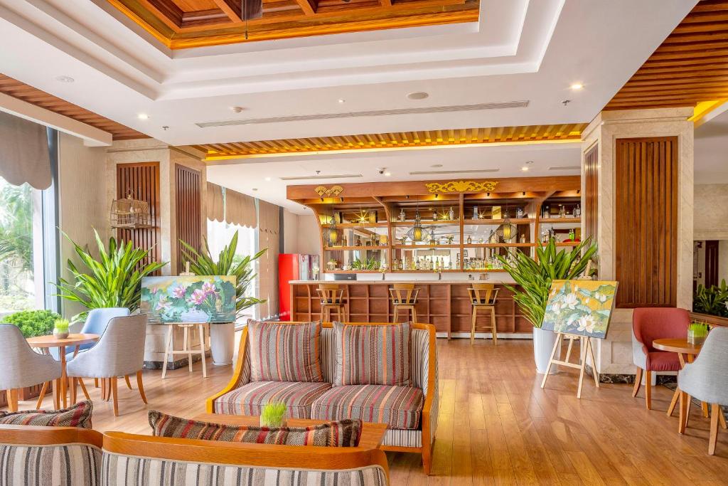 a lobby of a hotel with chairs and a bar at DLG Hotel Danang in Da Nang