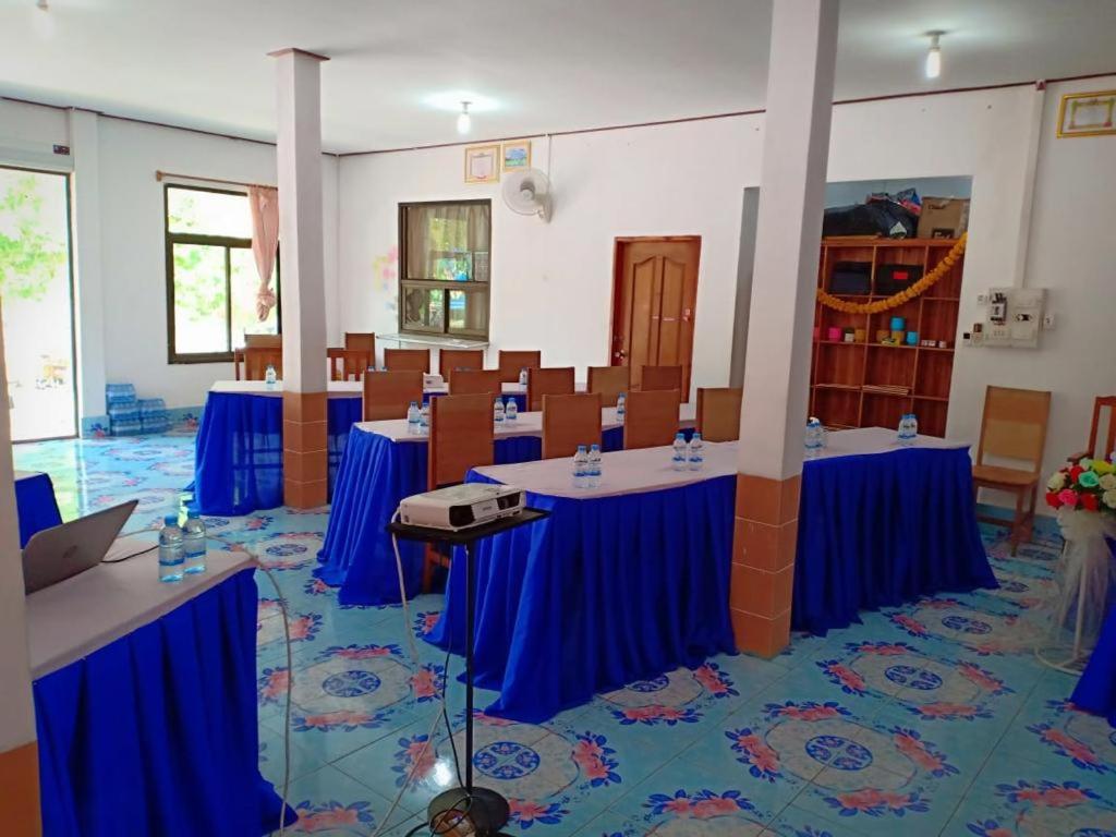 una sala de conferencias con mesas y sillas azules en Soutchai Resort, en Vientiane
