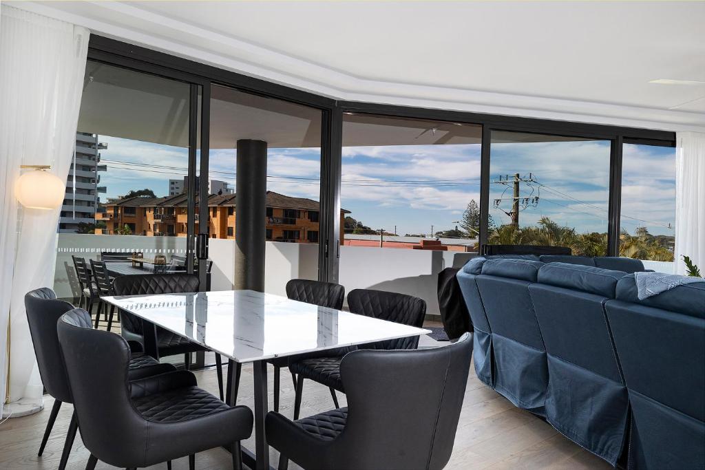 a dining room with a table and chairs at Serenity at Solaris 101 in Forster