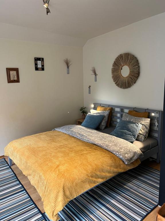 a bedroom with a large bed with blue pillows at Center studio hause in Kaunas