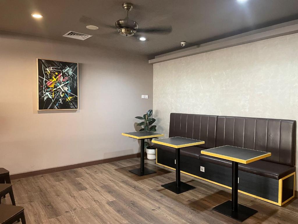 a waiting room with two benches and a painting on the wall at PassGo Digital Airport Terminal 2 Soekarno Hatta in Rawabagol