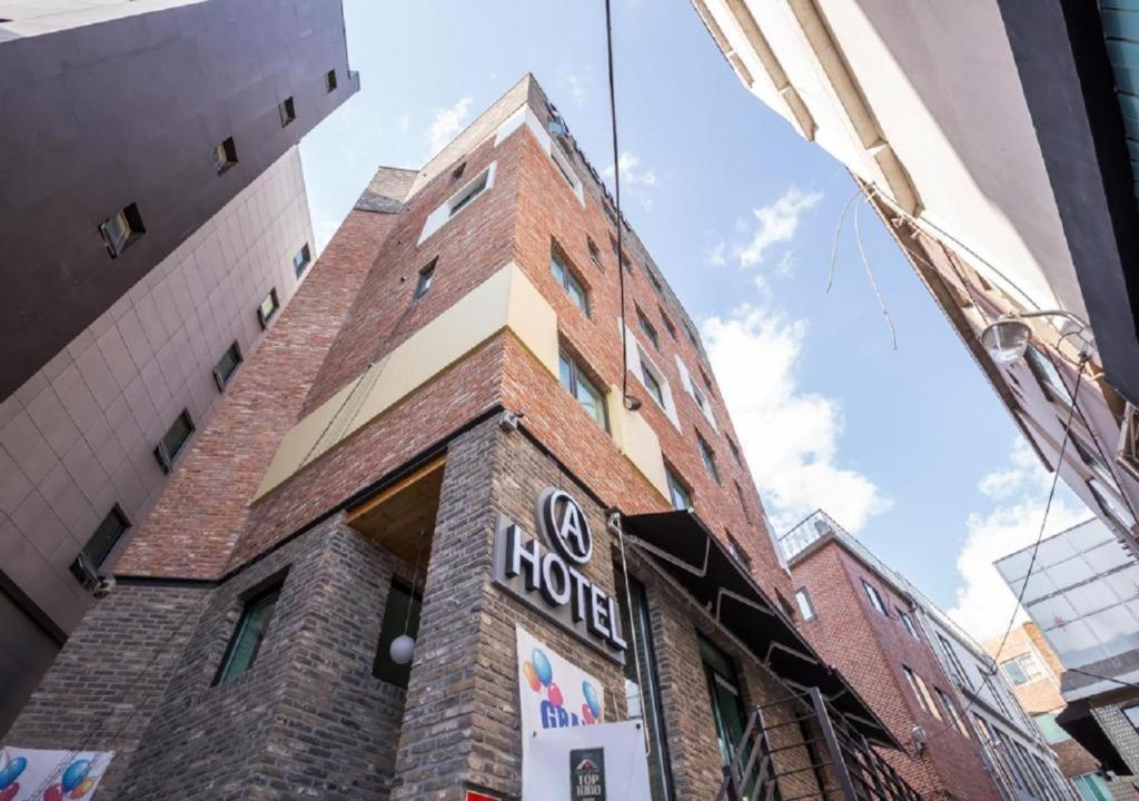 a tall brick building with a sign on it at Itaewon A One Hotel in Seoul