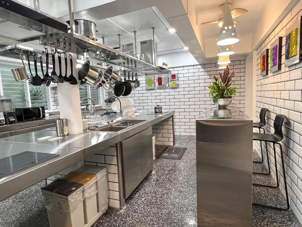 a kitchen with stainless steel counter tops in a kitchen at The Color Kata in Kata Beach