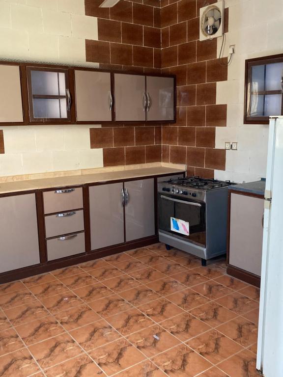 a kitchen with a stove and a counter top at تذكار in Qal'at Bishah