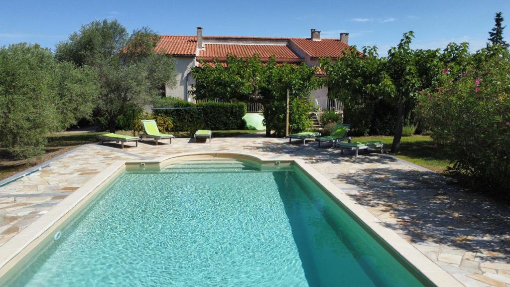a swimming pool in the backyard of a house at L'Abricotier in Malaucène