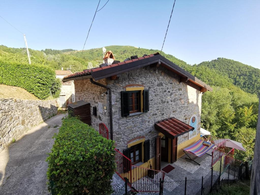 a person sitting on the roof of a house at Deliziosa Casetta Sull'Appennino Toscano in Montefegatesi