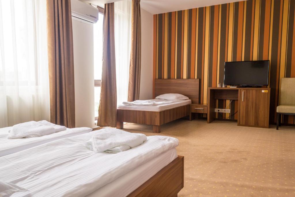 Postel nebo postele na pokoji v ubytování Hotel Mariss