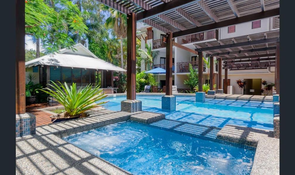 a swimming pool in the middle of a house at Charming 1 bedroom Apt - Close to Town & Beach in Port Douglas