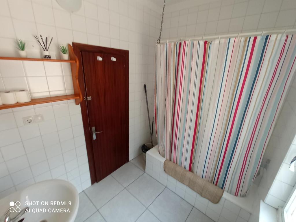 ein Bad mit einem Duschvorhang und einem WC in der Unterkunft Casa sella Asturias in Les Arriondes