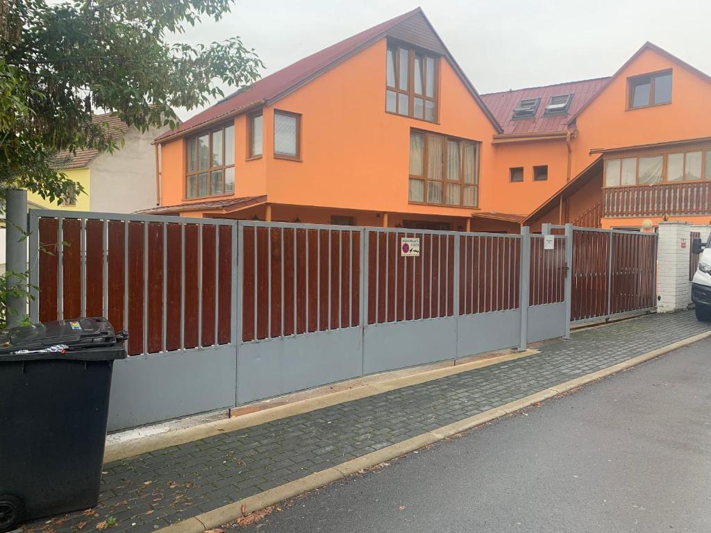 een oranje huis met een hek ervoor bij Helen Villa free parking in Prague in Praag