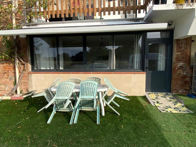 a group of chairs and a table in the grass at appartement de charme proche de Moissac in Labastide-du-Temple