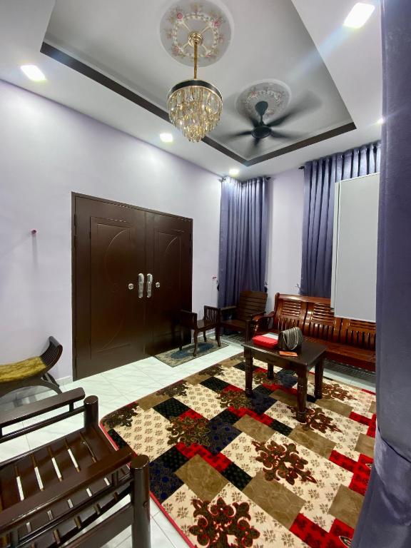 a living room with a couch and a ceiling at Sheri homestay in Kuala Nerang