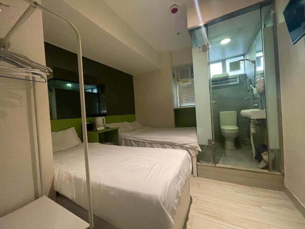 Postel nebo postele na pokoji v ubytování 珀依旅馆 Pop E INN
