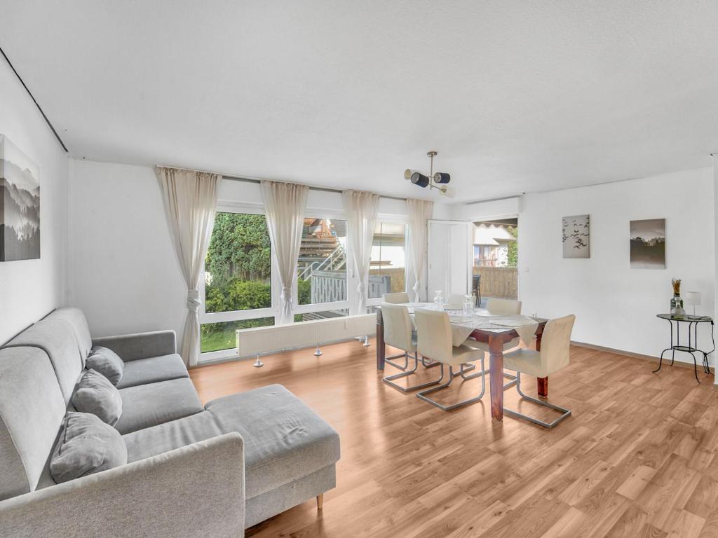 a living room with a couch and a table at Work & Stay in Adelheitsdorf in Adelheidsdorf