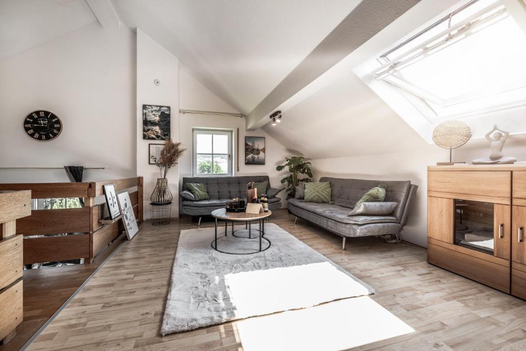 a living room with a couch and a table at Vitaloase Bad Griesbach im Rottal/70qm/Auszeit/Parkplatz in Bad Griesbach
