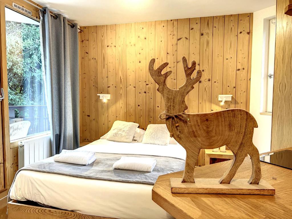 une statue en bois d'un cerf dans une chambre dans l'établissement Le Caribou, à Chamonix-Mont-Blanc