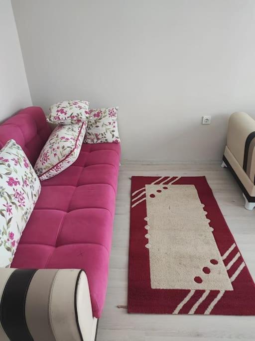a purple couch sitting on the floor in a room at Студия комфорт Comfort Studio كومفورت ستوديو 112 in Çınarcık