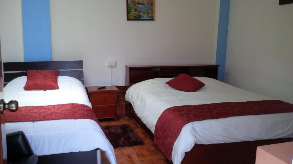 Postel nebo postele na pokoji v ubytování Hostal el Parque Tababela