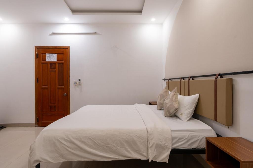 Postel nebo postele na pokoji v ubytování Lynk Stay Hoian