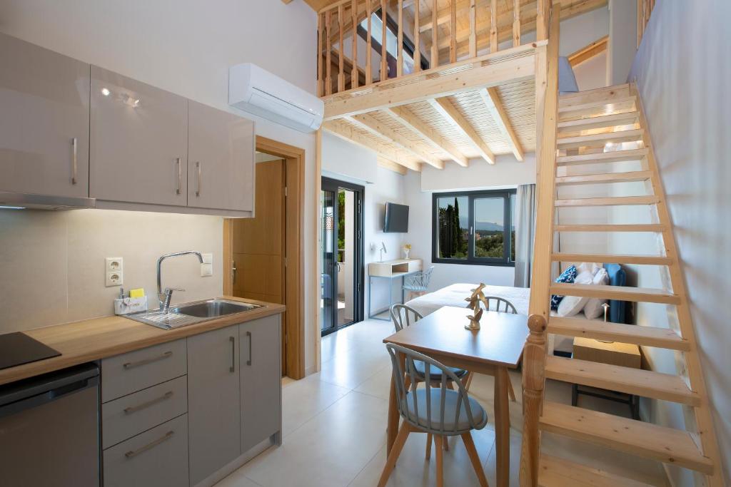 una cucina e un soggiorno con scala in una casetta minuscola di Zisis Suites a Nydri