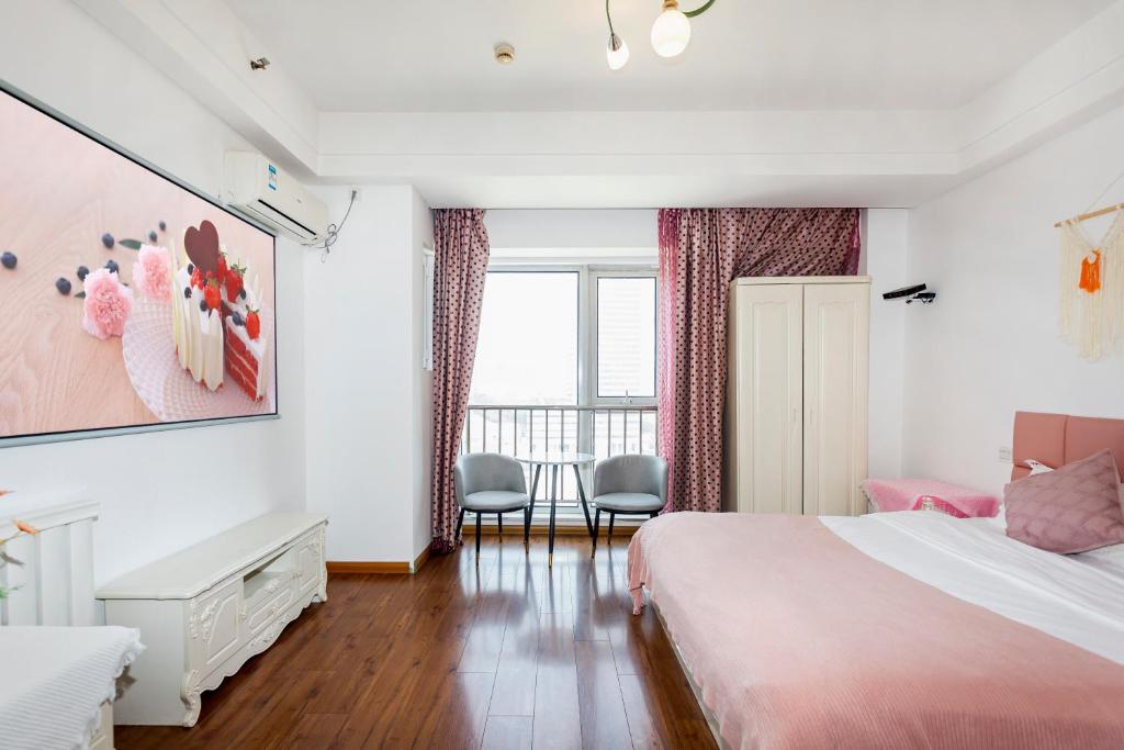 Postel nebo postele na pokoji v ubytování Dalian Hong Xi Yuan Apartment Wanda Plaza