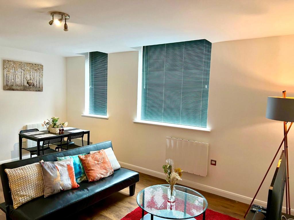 a living room with a couch and a table at Captivating 2-Bed Apartment in Bedford in Bedford