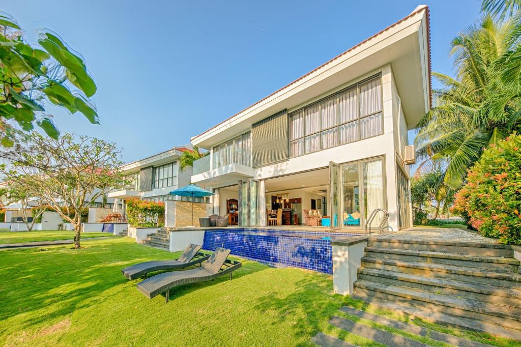 an exterior view of a house with a yard at Tran Beach Front Luxury Villa in Da Nang
