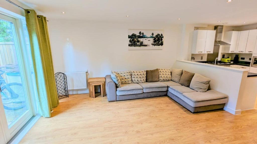 a living room with a couch and a kitchen at 3 Bedroom house in Camberwell in London