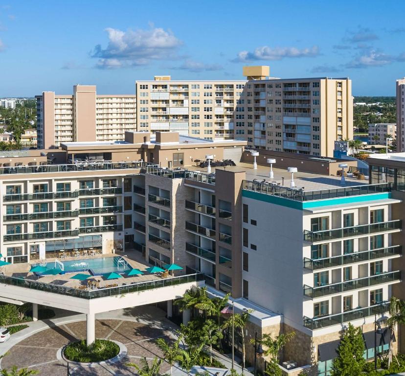 an aerial view of a building with a swimming pool at Tru By Hilton Pompano Beach Pier in Pompano Beach