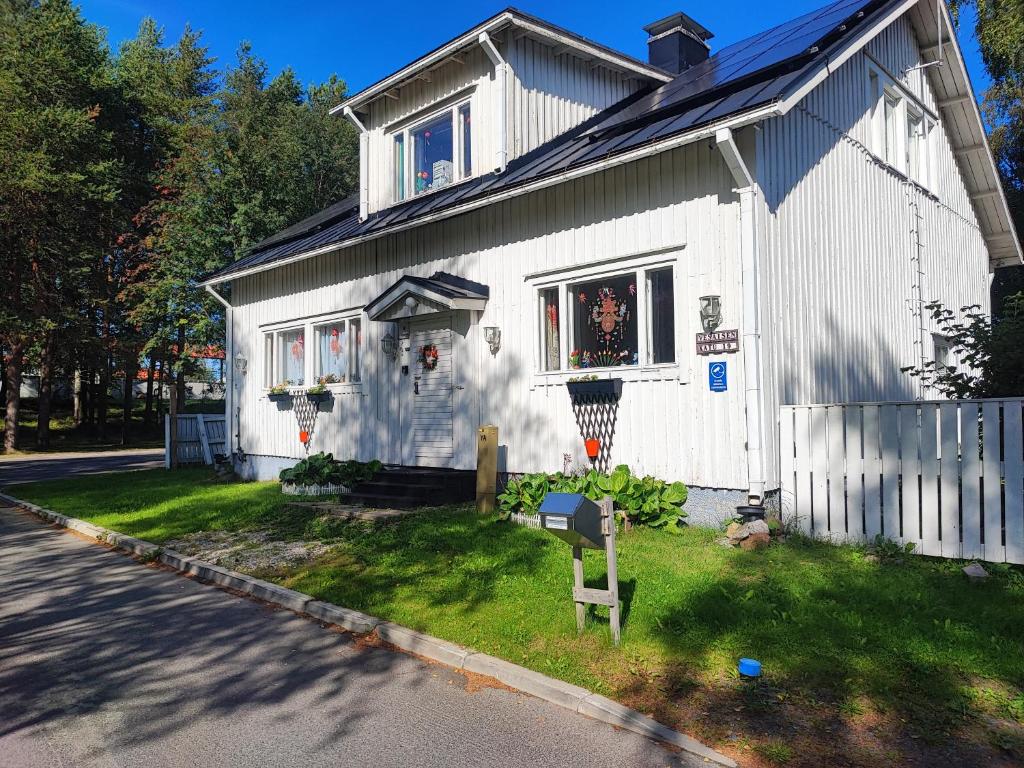 a white house with a fence in front of it at Half a house w/your own door, 60m2 in Tornio