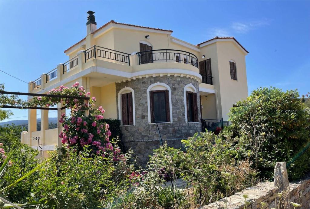 a large house with a balcony on top of it at Litani House in Raches