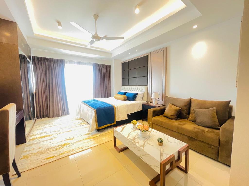 a hotel room with a bed and a couch at Ocean breeze Hotel Studio Negombo by Shane in Negombo