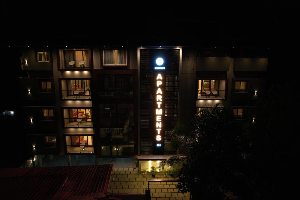 un edificio con un cartel de hotel por la noche en Ncomforts Luxurious Apartments, en Perintalmanna