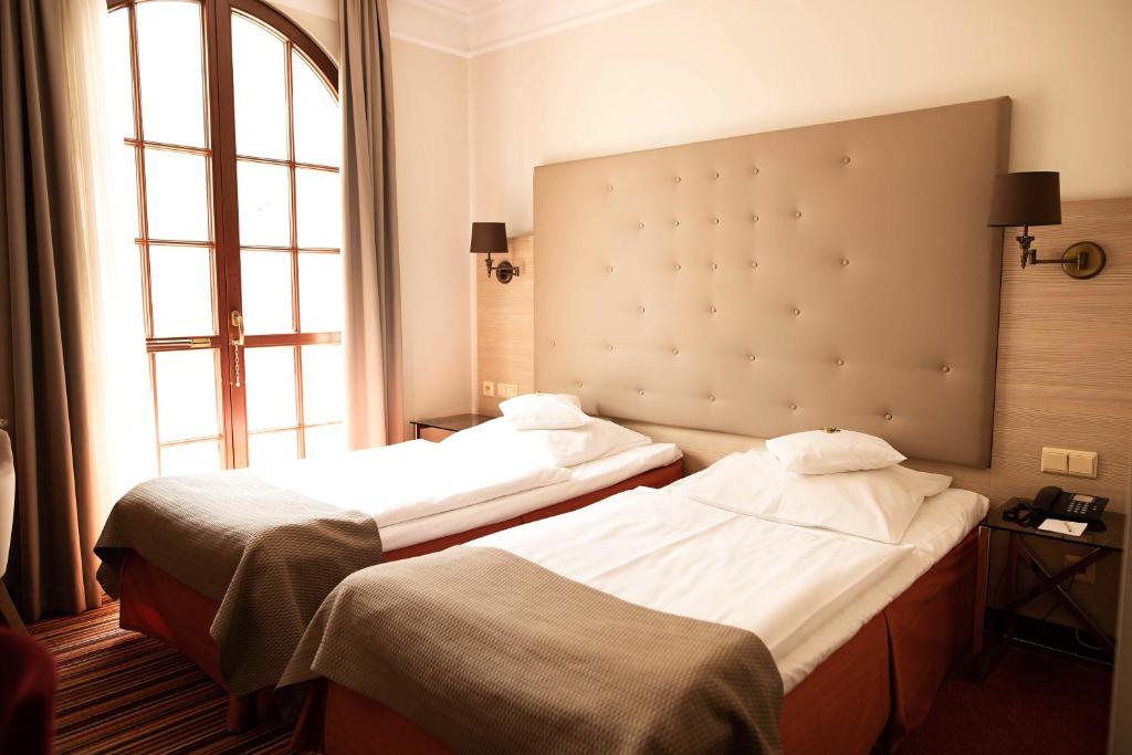 Postel nebo postele na pokoji v ubytování Hotel Branicki