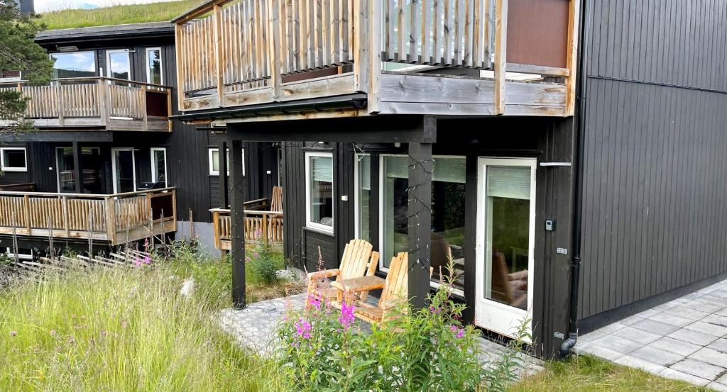 a house with a deck and a balcony at Geilotunet H224 - 6 person apartment in Geilo