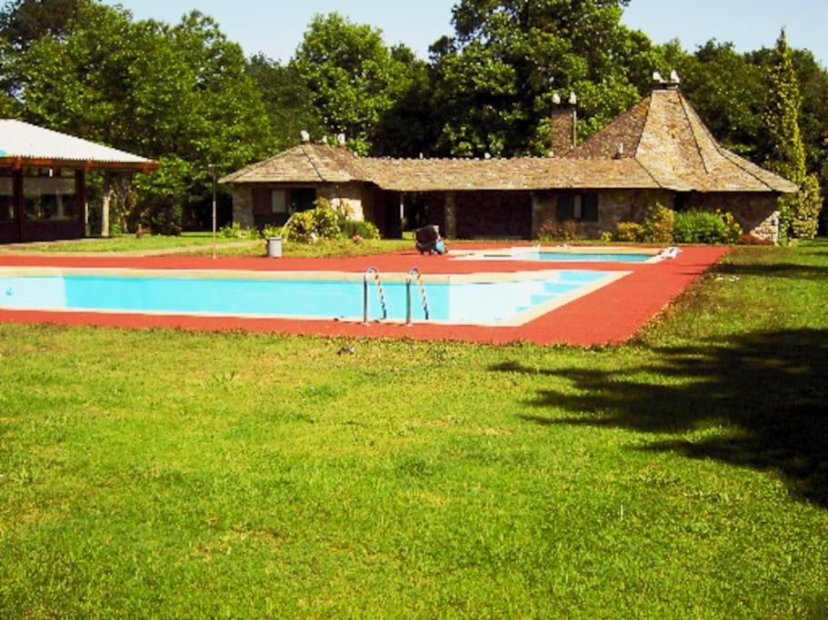 a large swimming pool in a yard with a house at Casa Vilanova in A Coruña