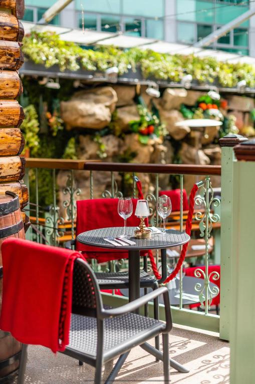 a table and chairs with wine glasses on a patio at Harcourt Hotel in Dublin