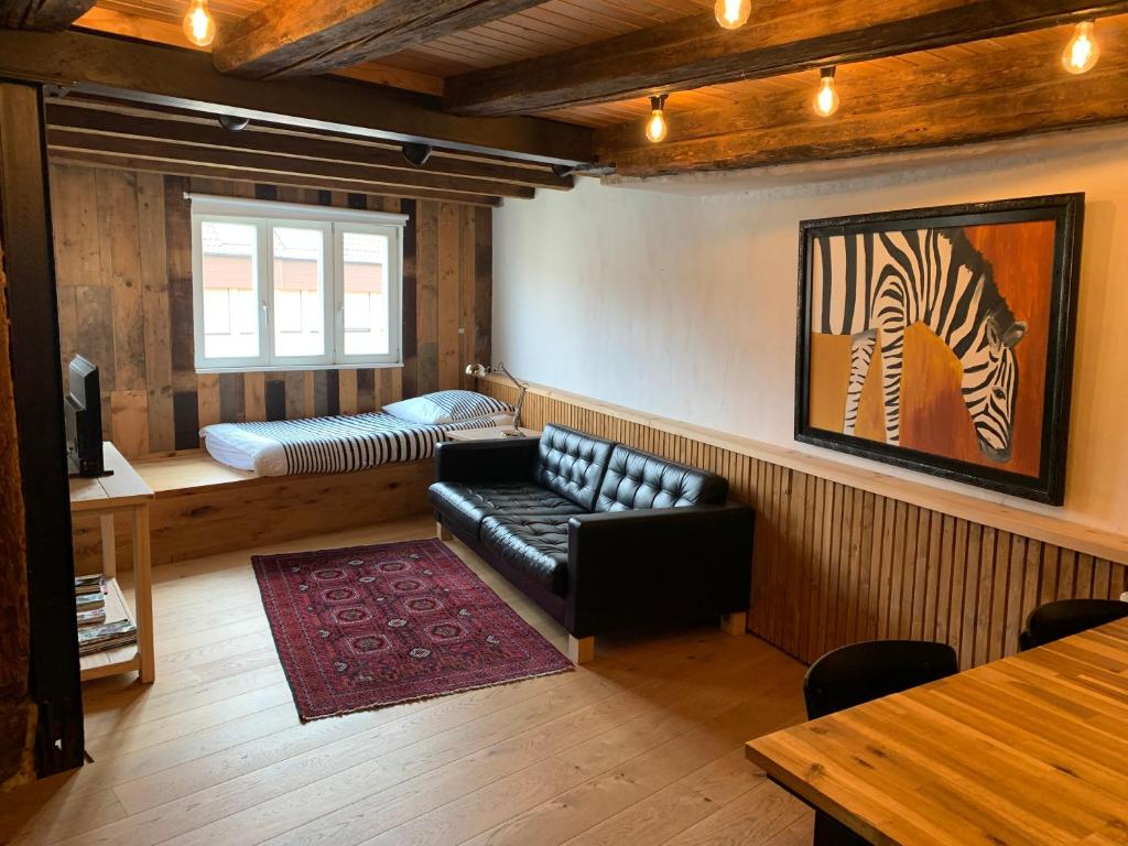 a living room with a couch and a zebra picture at Hausele in Sulzbach an der Murr