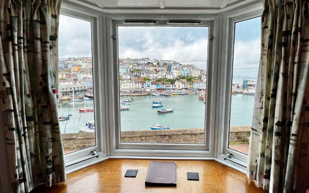 a large window with a view of a harbor at Fisherman's Wharf in Brixham