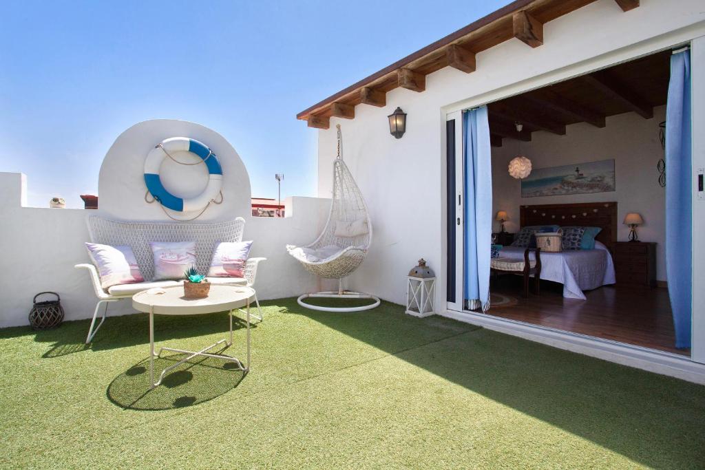 a patio with a room with a bed and a table at Vista Tostón in Cotillo