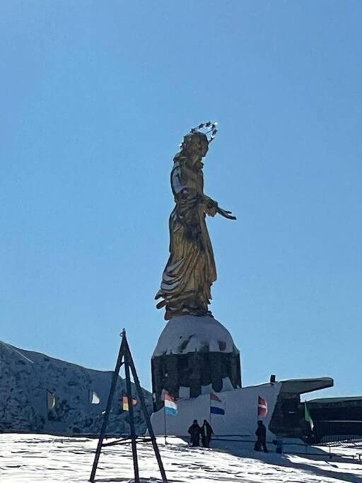 a statue of a woman standing in the snow at Appartamento Kern-Sciare A Portata Di Mano- in Madesimo