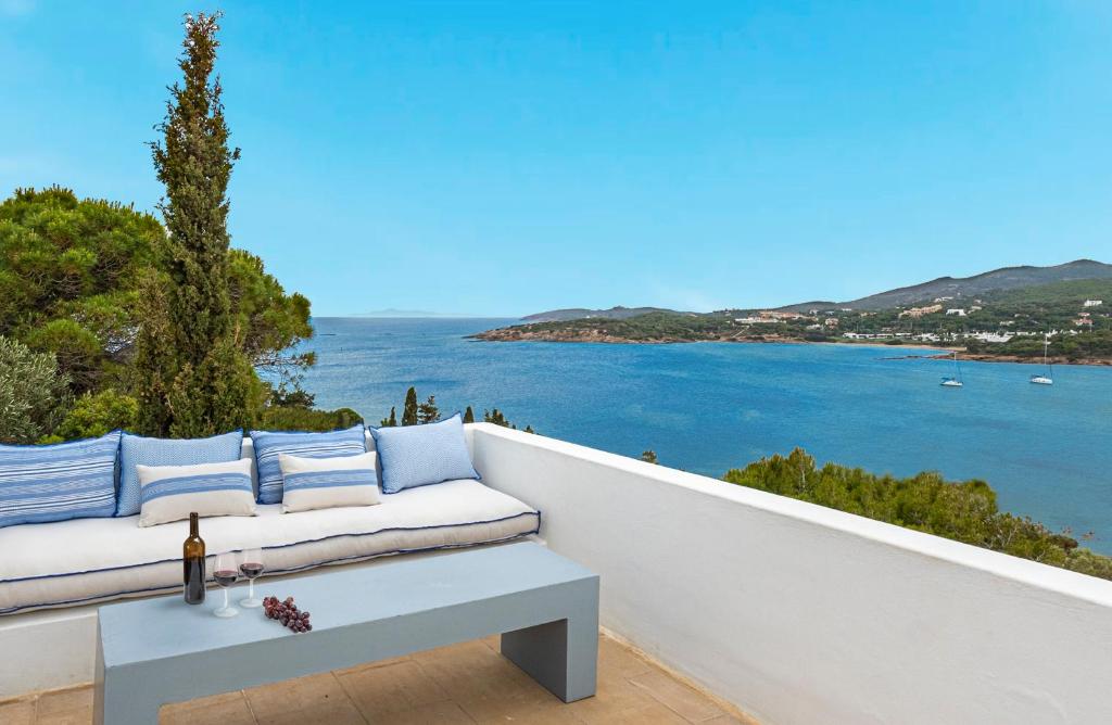 a white couch on a balcony overlooking the water at Hidesign Athens Villa In Sounio in Sounio