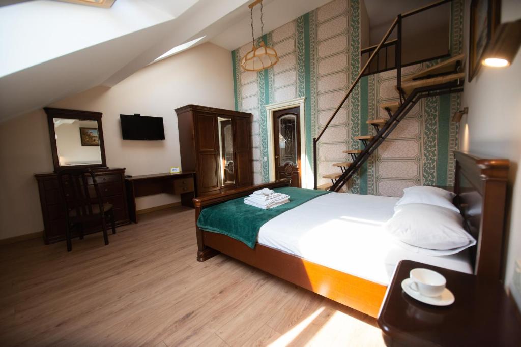 a bedroom with a bed and a stair case at Apart Yaroslava Osmomysla 9 Square - city center in Lviv